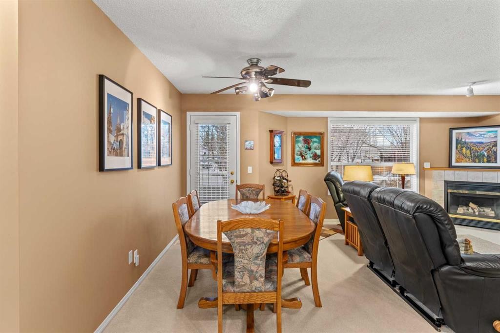 39 Mt Aberdeen Manor Se, Calgary, AB - Indoor Photo Showing Dining Room With Fireplace