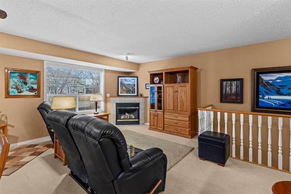 39 Mt Aberdeen Manor Se, Calgary, AB - Indoor Photo Showing Other Room With Fireplace