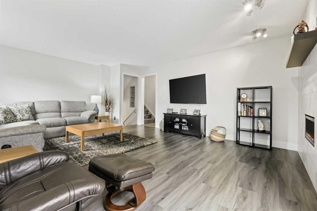 103 Sandarac Place Nw, Calgary, AB - Indoor Photo Showing Living Room With Fireplace