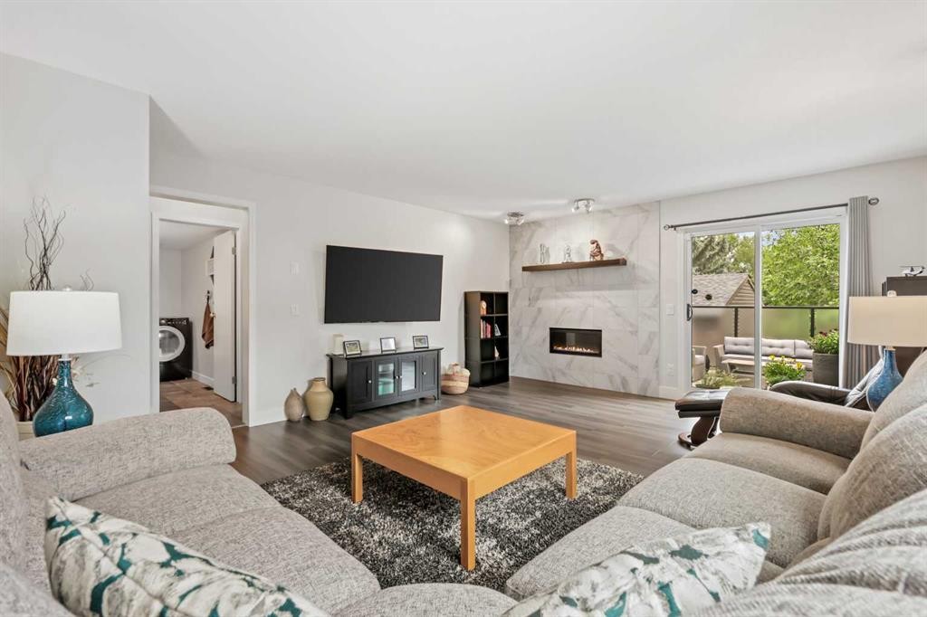 103 Sandarac Place Nw, Calgary, AB - Indoor Photo Showing Living Room With Fireplace