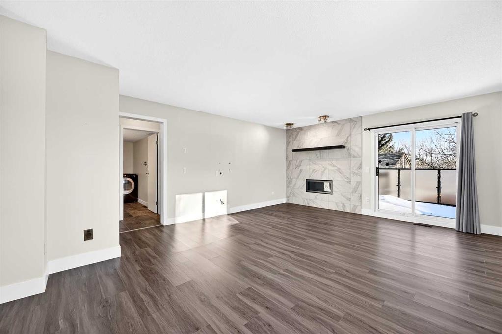 103 Sandarac Place Nw, Calgary, AB - Indoor Photo Showing Living Room With Fireplace