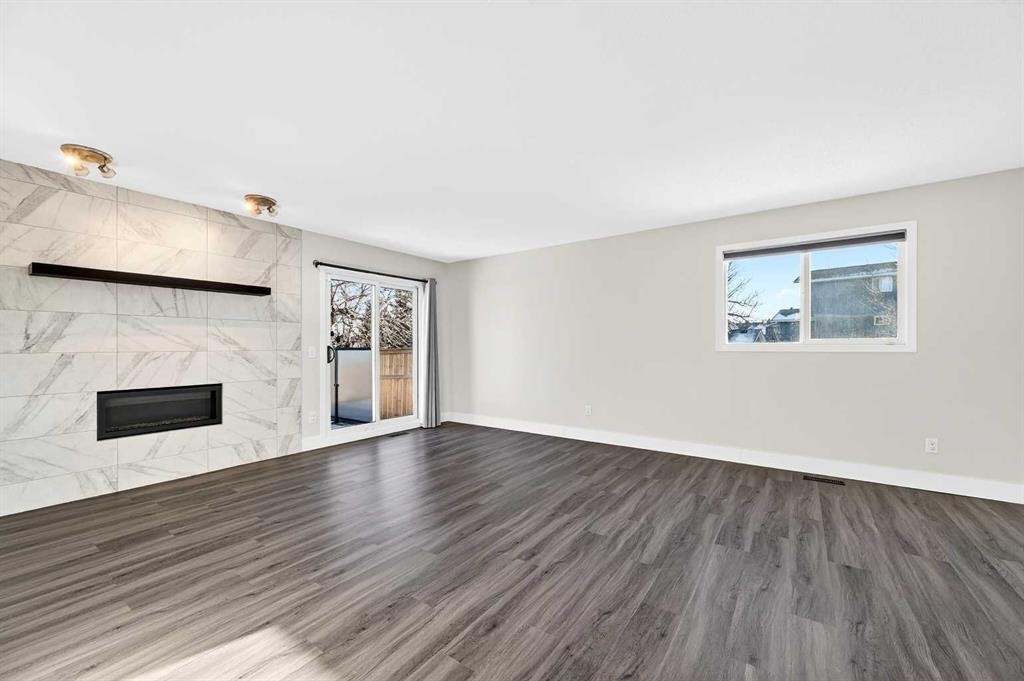 103 Sandarac Place Nw, Calgary, AB - Indoor Photo Showing Other Room With Fireplace