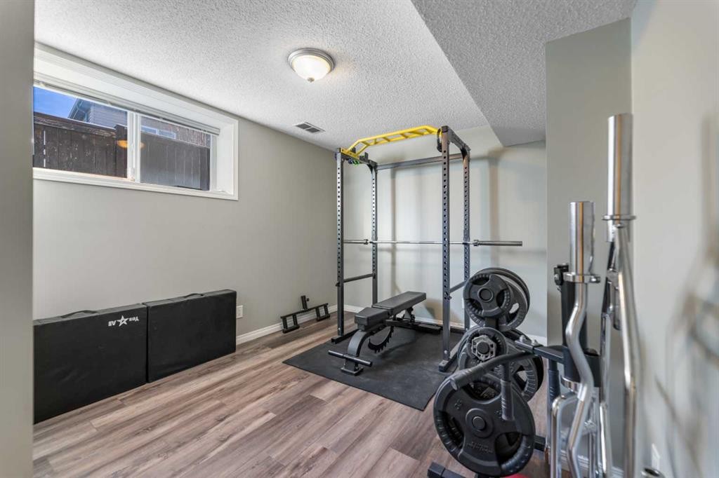 8 Copperfield Manor Se, Calgary, AB - Indoor Photo Showing Gym Room