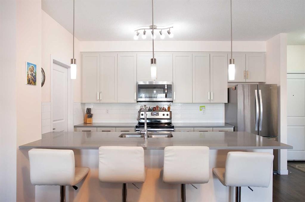 103-200 Cranfield Common Se, Calgary, AB - Indoor Photo Showing Kitchen With Stainless Steel Kitchen With Double Sink With Upgraded Kitchen