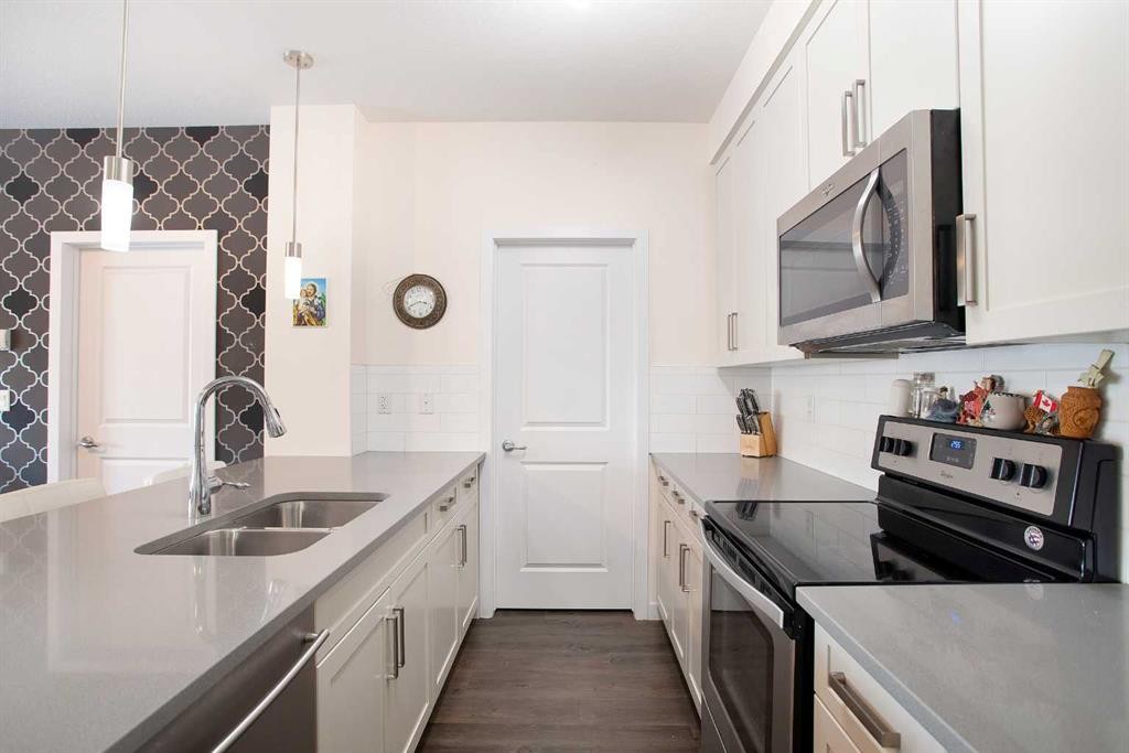 103-200 Cranfield Common Se, Calgary, AB - Indoor Photo Showing Kitchen With Stainless Steel Kitchen With Double Sink With Upgraded Kitchen