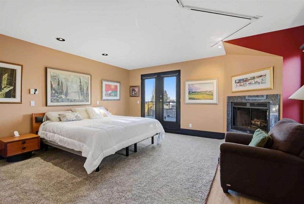 64 Patterson Mews Sw, Calgary, AB - Indoor Photo Showing Bedroom With Fireplace