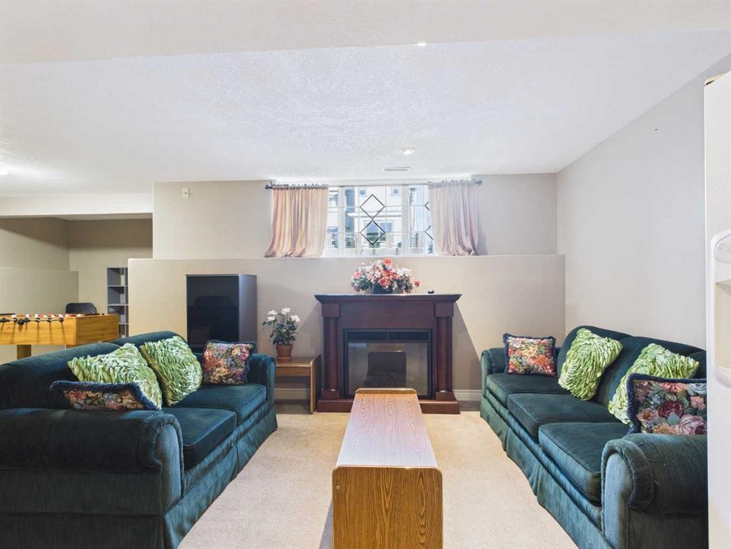107 Panatella Close Nw, Calgary, AB - Indoor Photo Showing Living Room With Fireplace