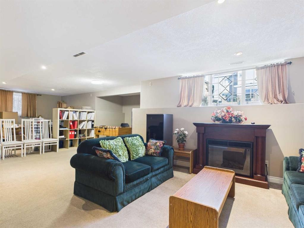 107 Panatella Close Nw, Calgary, AB - Indoor Photo Showing Living Room With Fireplace