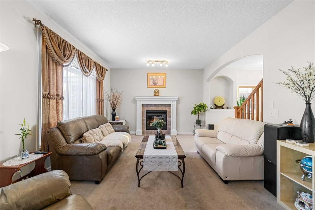107 Panatella Close Nw, Calgary, AB - Indoor Photo Showing Living Room With Fireplace