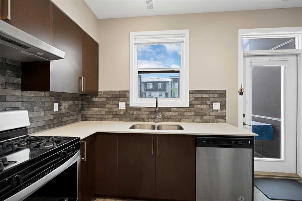 203-350 Redstone Ne, Calgary, AB - Indoor Photo Showing Kitchen With Double Sink