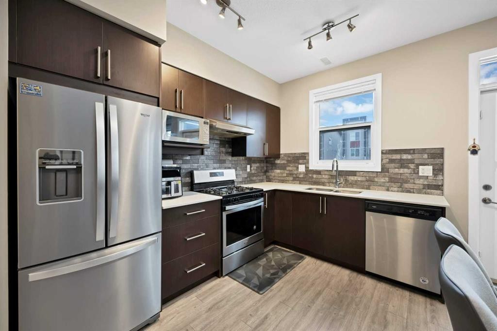 203-350 Redstone Ne, Calgary, AB - Indoor Photo Showing Kitchen With Stainless Steel Kitchen