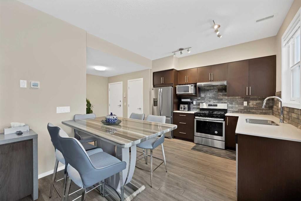 203-350 Redstone Ne, Calgary, AB - Indoor Photo Showing Kitchen With Stainless Steel Kitchen