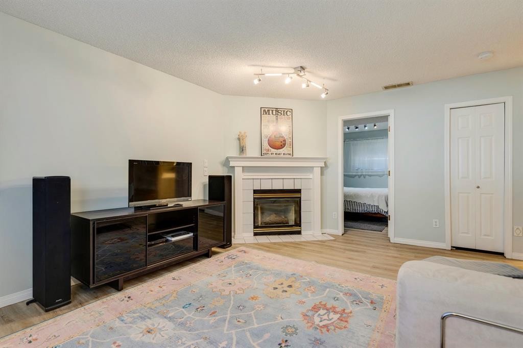 19 Sunlake Gardens Se, Calgary, AB - Indoor Photo Showing Living Room With Fireplace