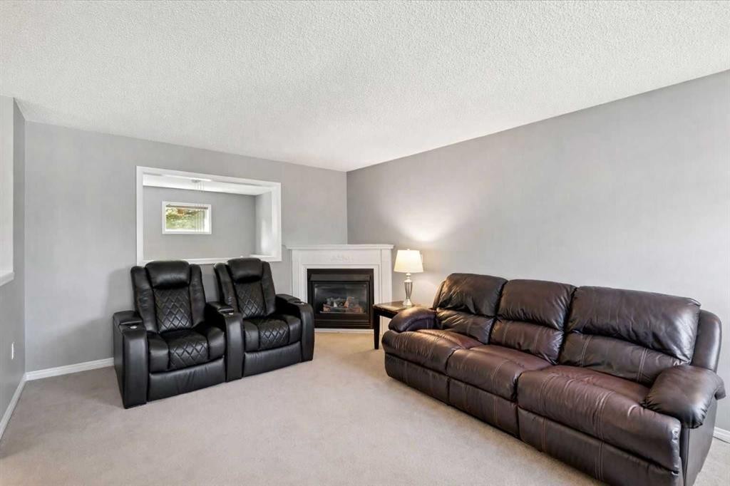 22 Country Hills Cove Nw, Calgary, AB - Indoor Photo Showing Living Room With Fireplace