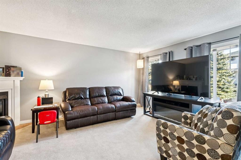 22 Country Hills Cove Nw, Calgary, AB - Indoor Photo Showing Living Room With Fireplace