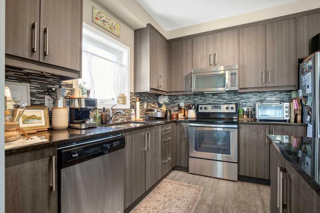 321-402 Marquis Lane Se, Calgary, AB - Indoor Photo Showing Kitchen With Stainless Steel Kitchen With Double Sink