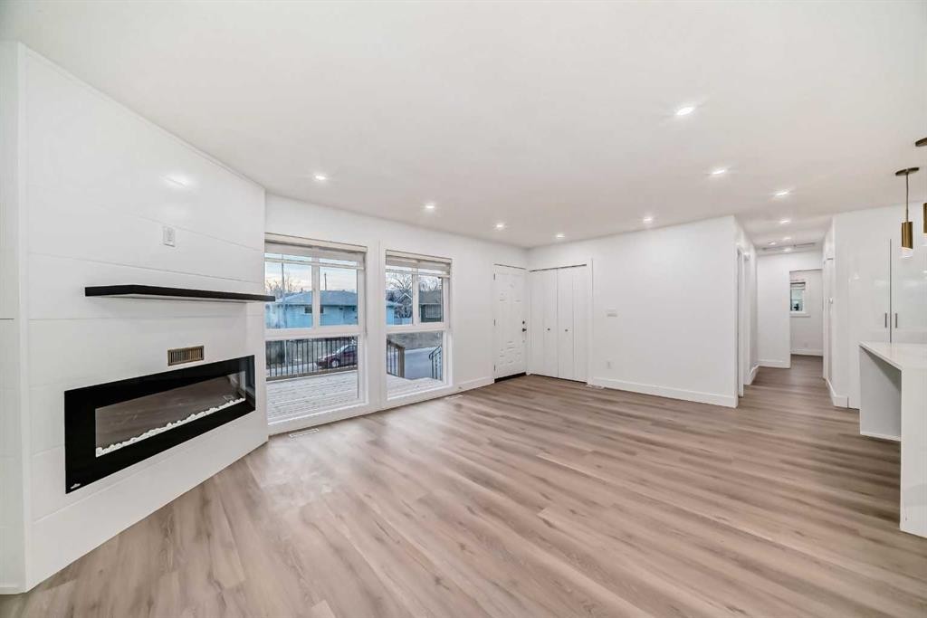 304 Huntbourne Hill Ne, Calgary, AB - Indoor Photo Showing Other Room With Fireplace