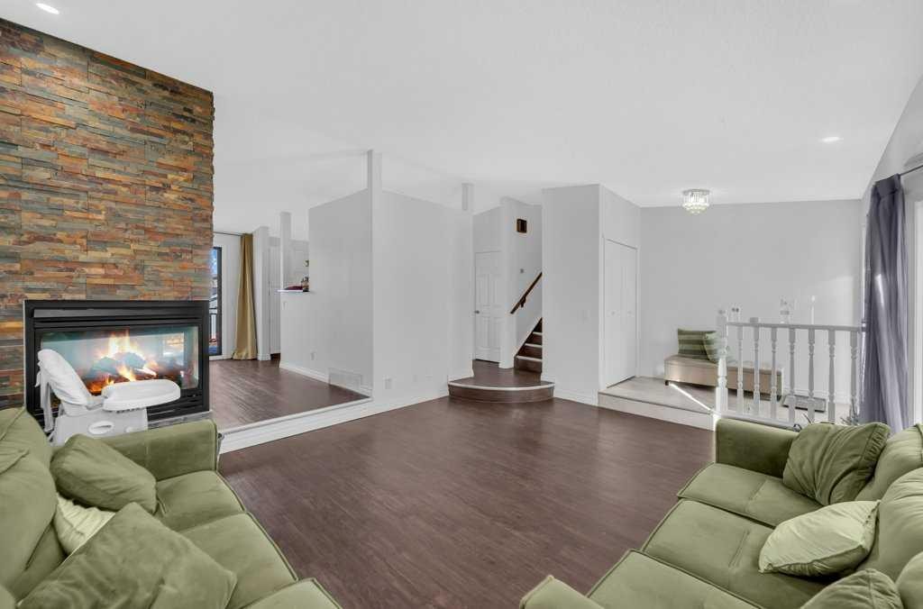 64 Castledale Crescent Ne, Calgary, AB - Indoor Photo Showing Living Room With Fireplace