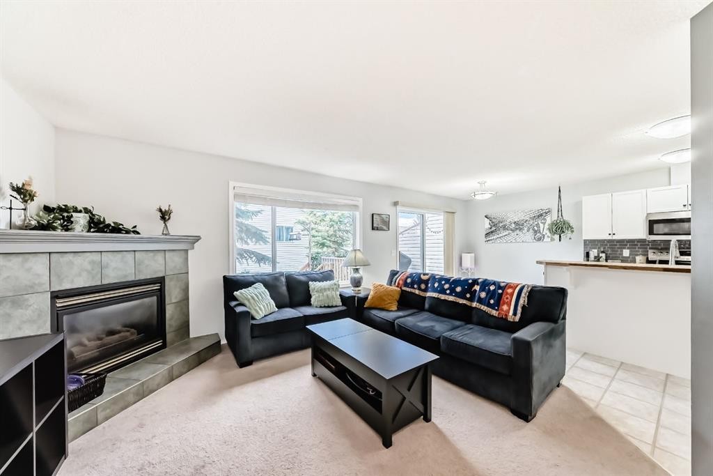 8-122 Bow Ridge Crescent, Cochrane, AB - Indoor Photo Showing Living Room With Fireplace
