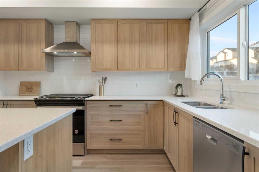 99 Edith Passage Nw, Calgary, AB - Indoor Photo Showing Kitchen With Double Sink