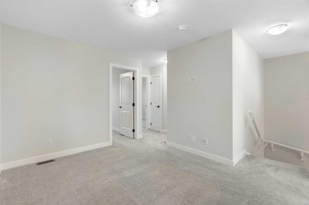 99 Edith Passage Nw, Calgary, AB - Indoor Photo Showing Other Room