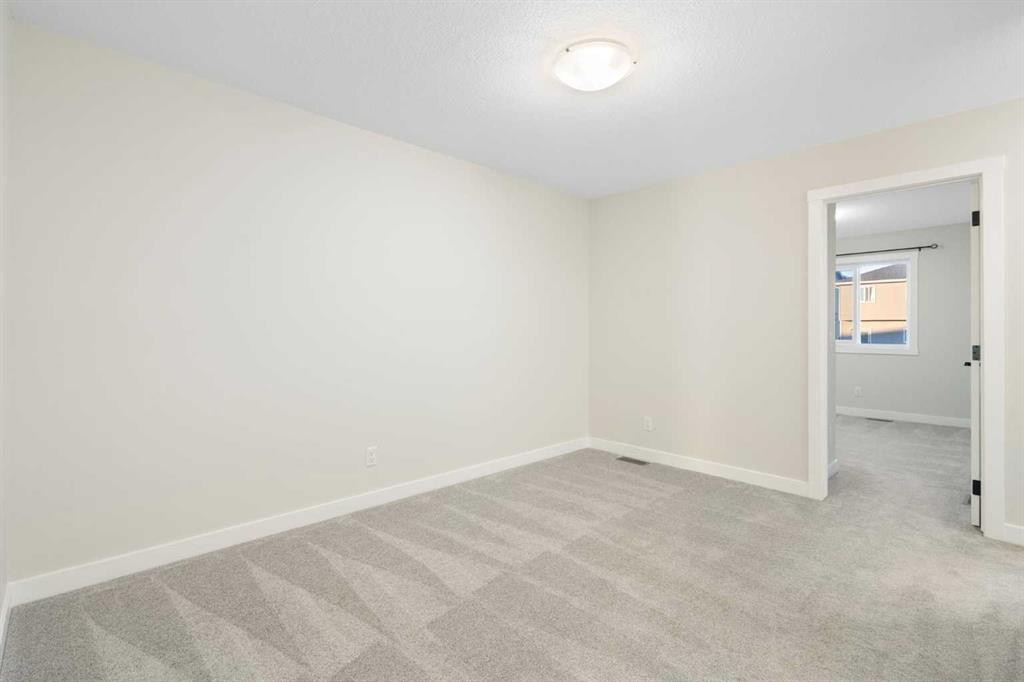 99 Edith Passage Nw, Calgary, AB - Indoor Photo Showing Other Room