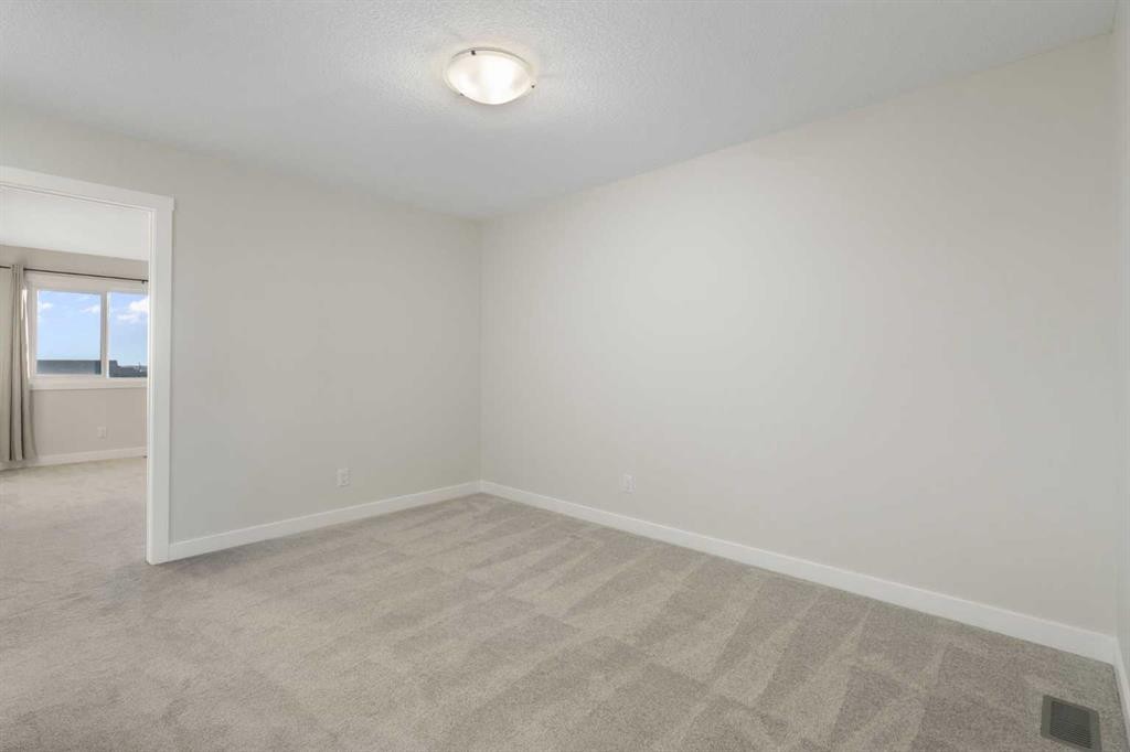99 Edith Passage Nw, Calgary, AB - Indoor Photo Showing Other Room