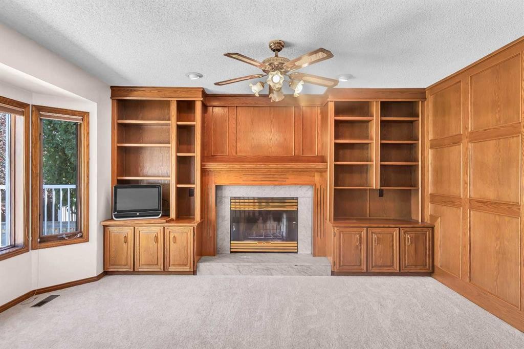 125 Edgebrook Road Nw, Calgary, AB - Indoor Photo Showing Other Room With Fireplace
