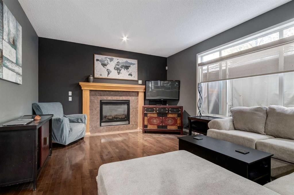 10 Chapala Road Se, Calgary, AB - Indoor Photo Showing Living Room With Fireplace