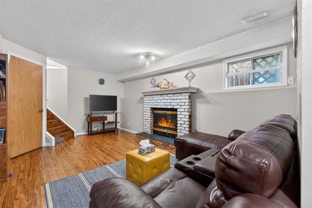 139 Castledale Way Ne, Calgary, AB - Indoor Photo Showing Living Room With Fireplace