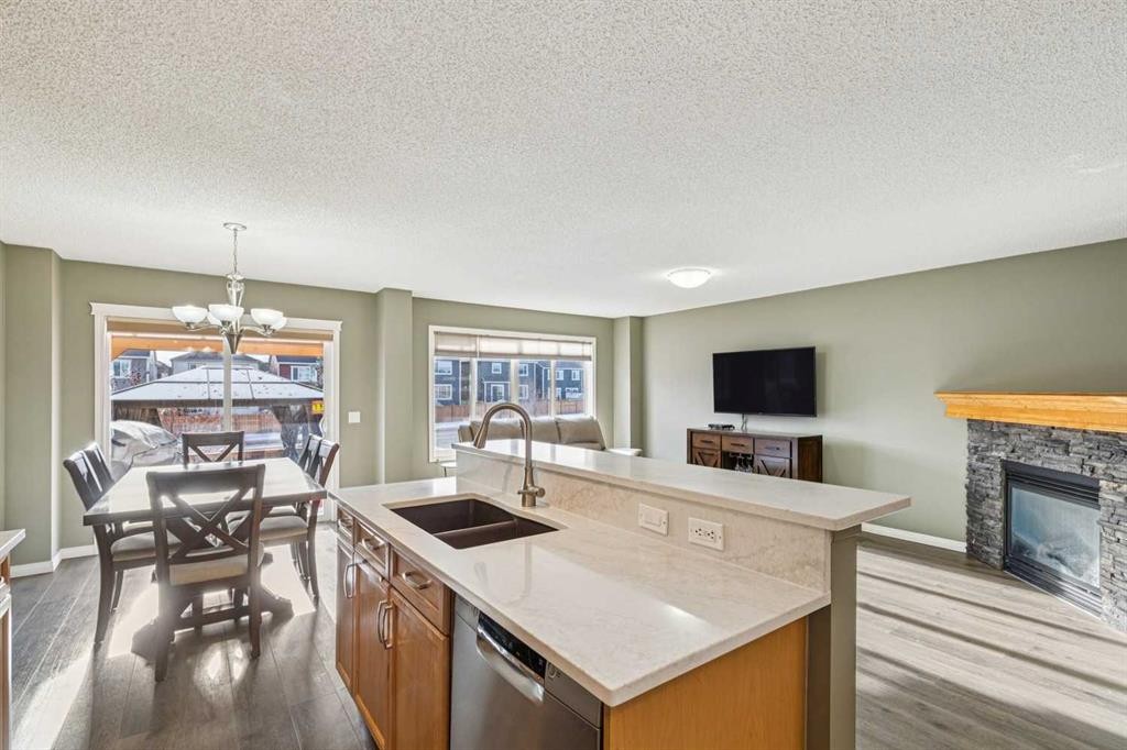 460 Silverado Plains Circle Sw, Calgary, AB - Indoor Photo Showing Kitchen With Fireplace With Double Sink