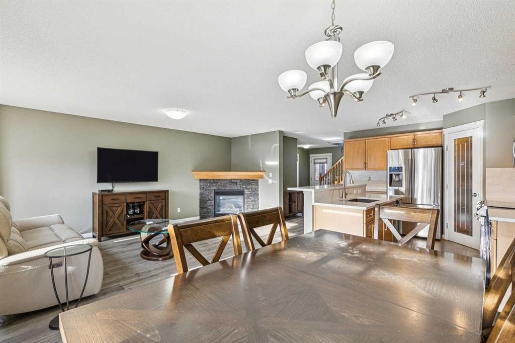 460 Silverado Plains Circle Sw, Calgary, AB - Indoor Photo Showing Dining Room With Fireplace