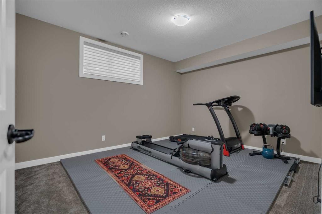 300 Aspenmere Way, Chestermere, AB - Indoor Photo Showing Gym Room