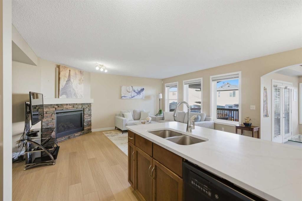 227 Panamount Circle Nw, Calgary, AB - Indoor Photo Showing Kitchen With Fireplace With Double Sink