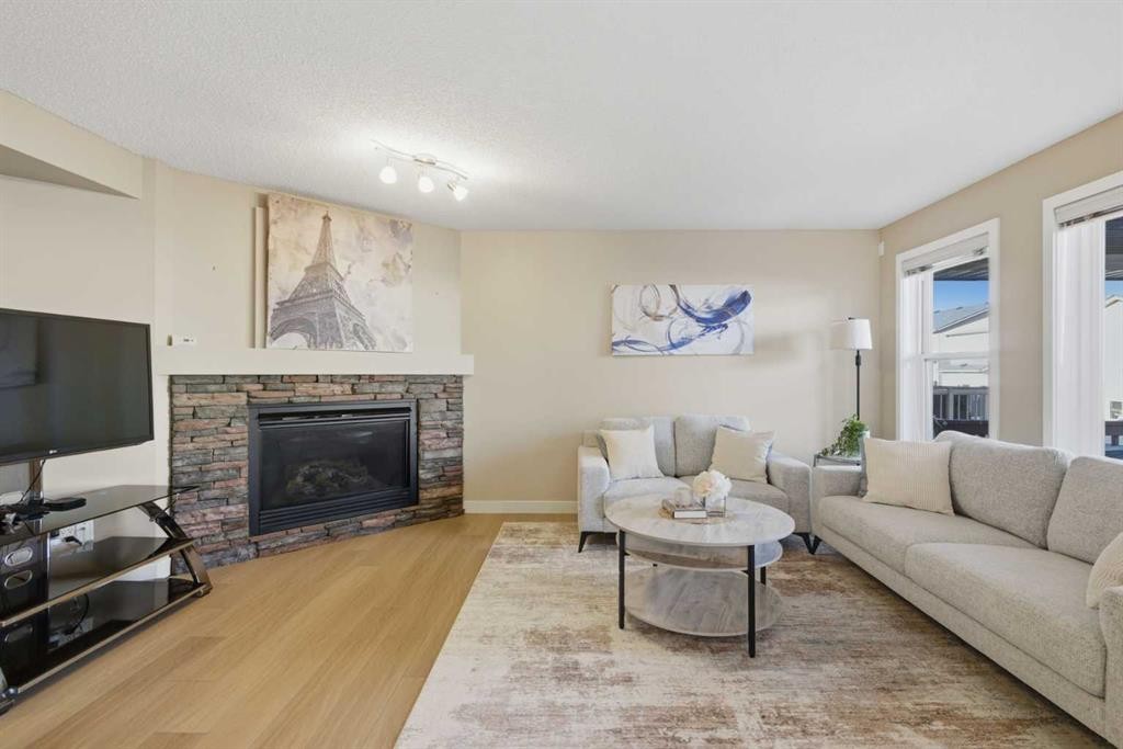 227 Panamount Circle Nw, Calgary, AB - Indoor Photo Showing Living Room With Fireplace