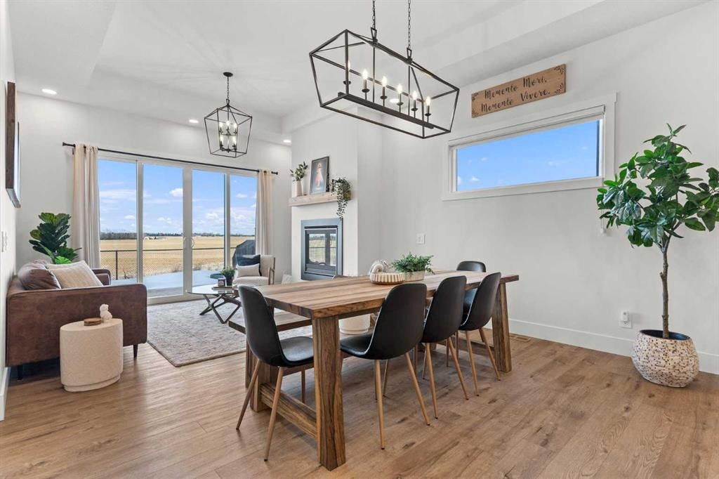 79 Sandpiper Bend, Chestermere, AB - Indoor Photo Showing Dining Room With Fireplace