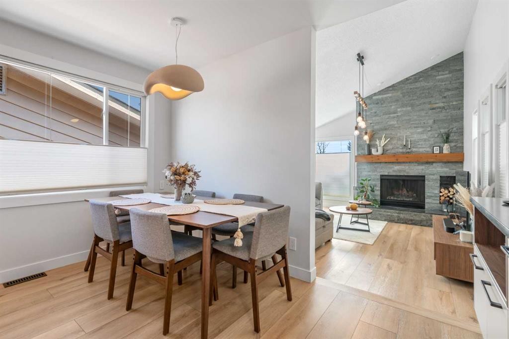 7132 36 Avenue Nw, Calgary, AB - Indoor Photo Showing Dining Room With Fireplace