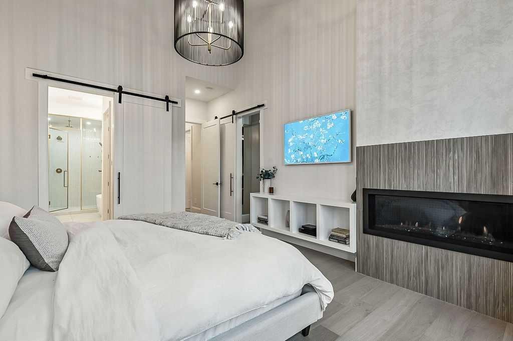 56 Lissington Drive Sw, Calgary, AB - Indoor Photo Showing Bedroom With Fireplace