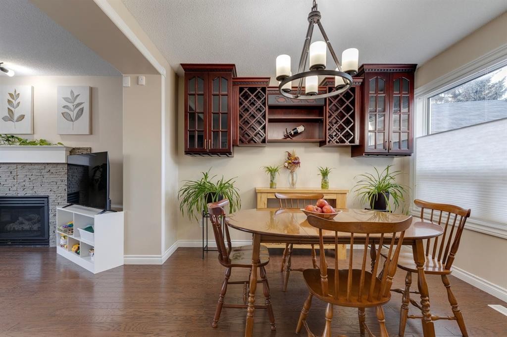 22 Hidden Spring Court Nw, Calgary, AB - Indoor Photo Showing Dining Room With Fireplace