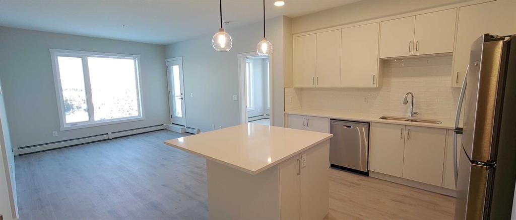 403-660 Shawnee Square Sw, Calgary, AB - Indoor Photo Showing Kitchen With Double Sink