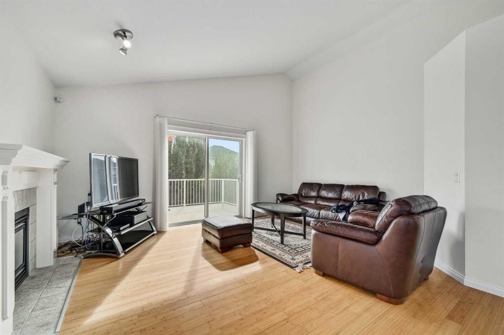 292 Arbour Crest Drive Nw, Calgary, AB - Indoor Photo Showing Living Room With Fireplace