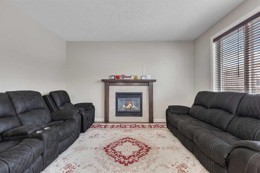 1564 Copperfield Boulevard Se, Calgary, AB - Indoor Photo Showing Living Room With Fireplace