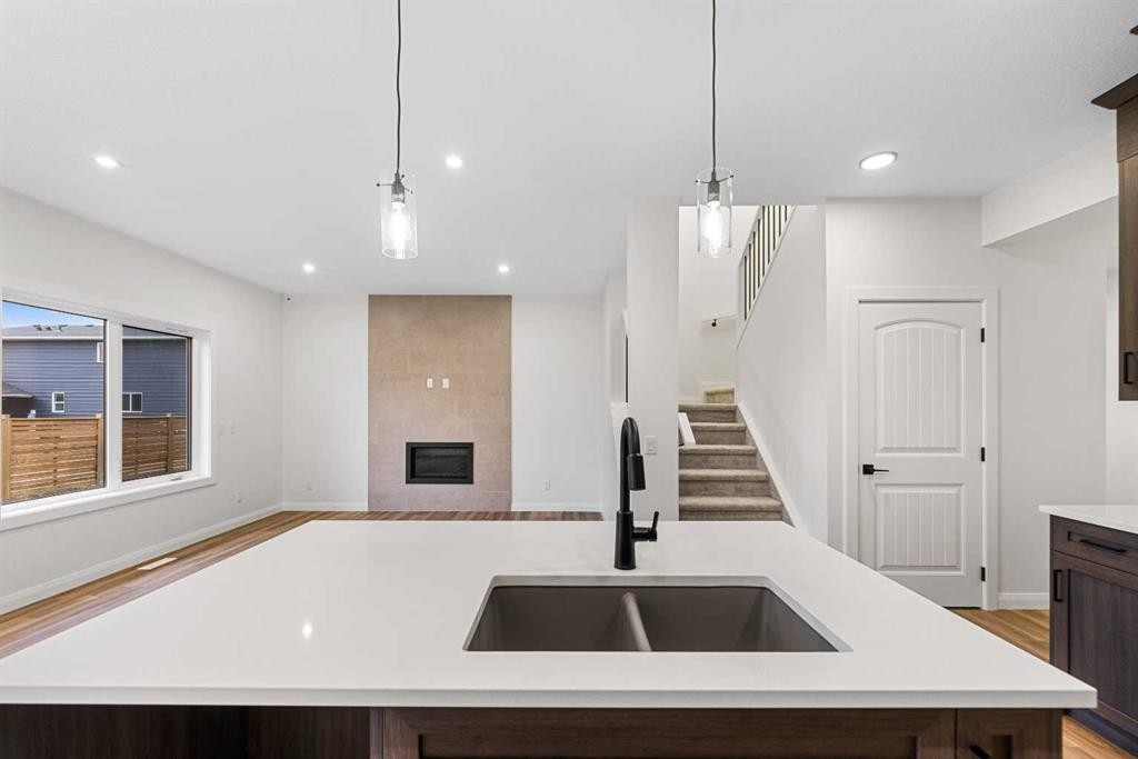 72 Dawson Wharf Mount, Chestermere, AB - Indoor Photo Showing Kitchen With Fireplace With Double Sink