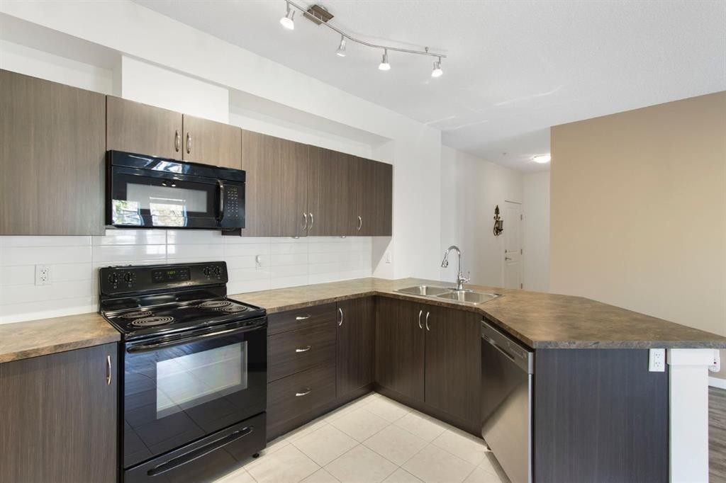 105-100 Cranfield Common Se, Calgary, AB - Indoor Photo Showing Kitchen With Double Sink