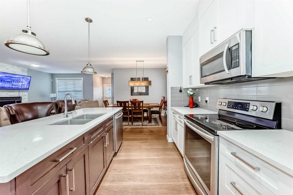 512 Baysprings Lane Sw, Airdrie, AB - Indoor Photo Showing Kitchen With Double Sink