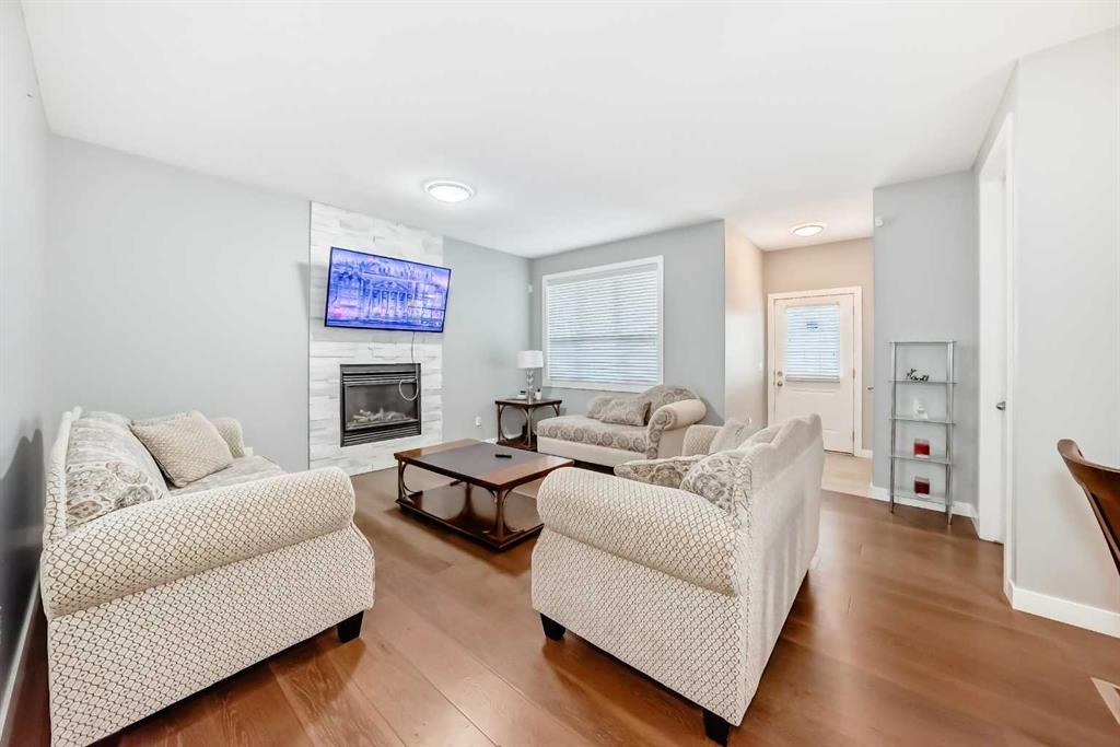 512 Baysprings Lane Sw, Airdrie, AB - Indoor Photo Showing Living Room With Fireplace
