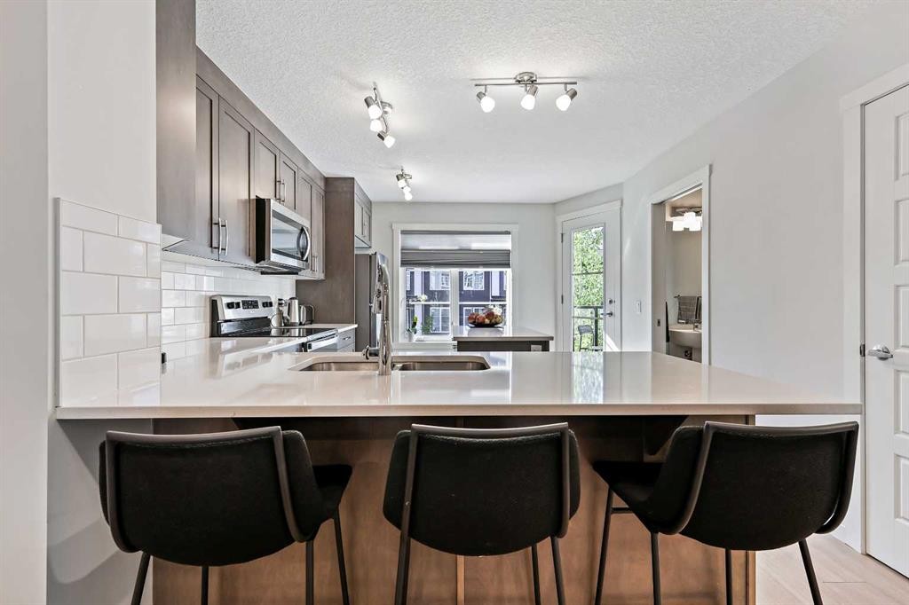 107-474 Seton Circle Se, Calgary, AB - Indoor Photo Showing Kitchen With Double Sink
