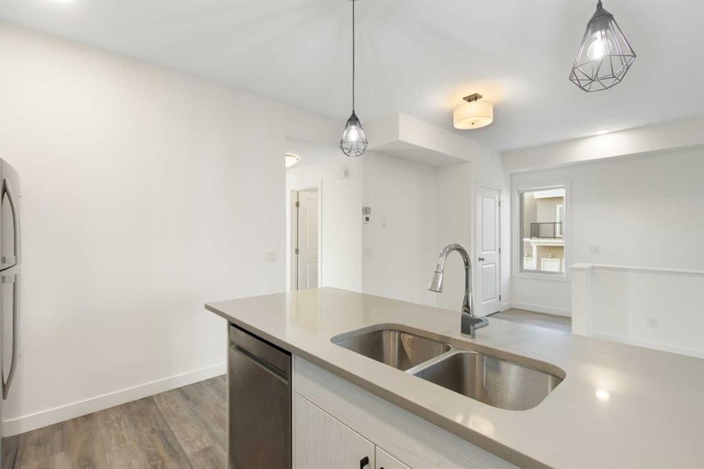 1301-24 Rivercrest Drive, Cochrane, AB - Indoor Photo Showing Kitchen With Double Sink