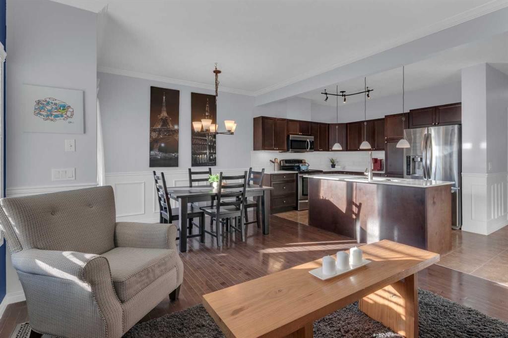 605-620 Luxstone Landing Sw, Airdrie, AB - Indoor Photo Showing Kitchen With Fireplace With Double Sink
