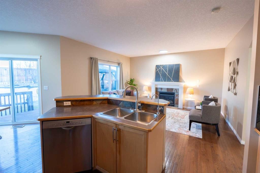 306 Rockyspring Circle Nw, Calgary, AB - Indoor Photo Showing Kitchen With Fireplace With Double Sink